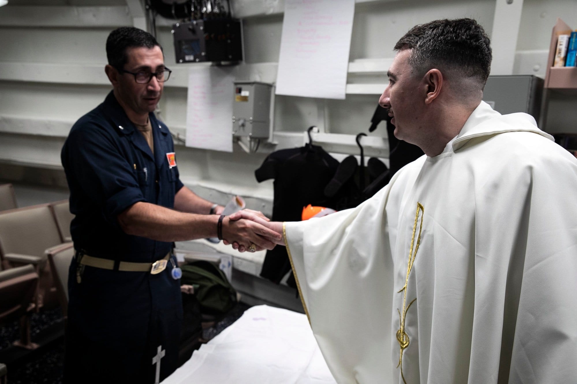 Chaplain Greets the Commanding Officer After Catholic Mass Aboard USS Sterett
