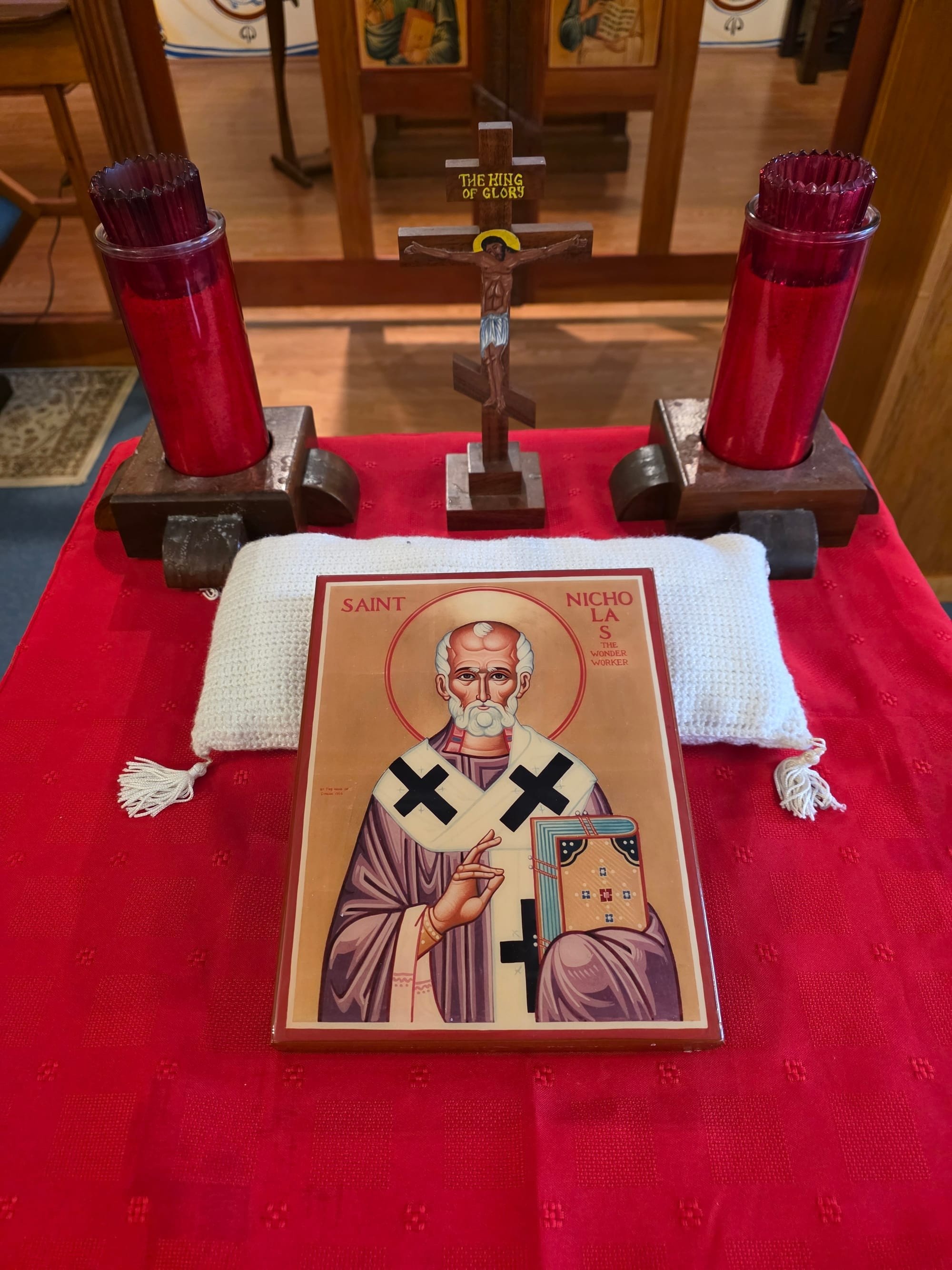 Icon of Saint Nicholas on a Red Cloth with Candles