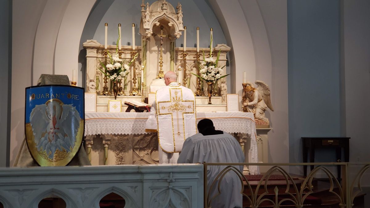 Priest Bowing at Latin Mass - Catholic Stock Photo