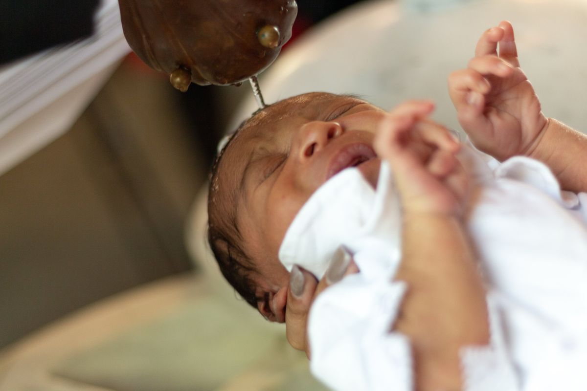 Black Catholic Infant Baptism - Catholic Stock Photo