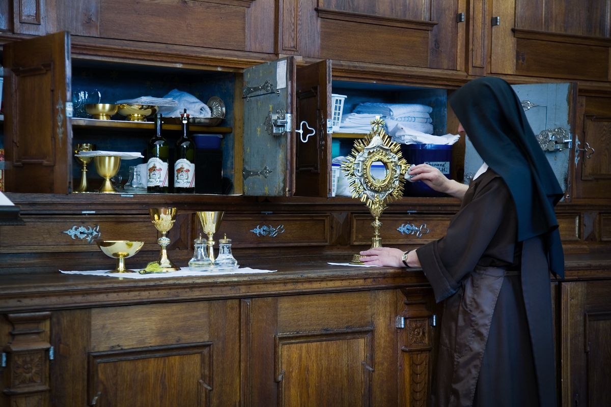 Nun Cleaning Monstrance - Catholic Stock Photo