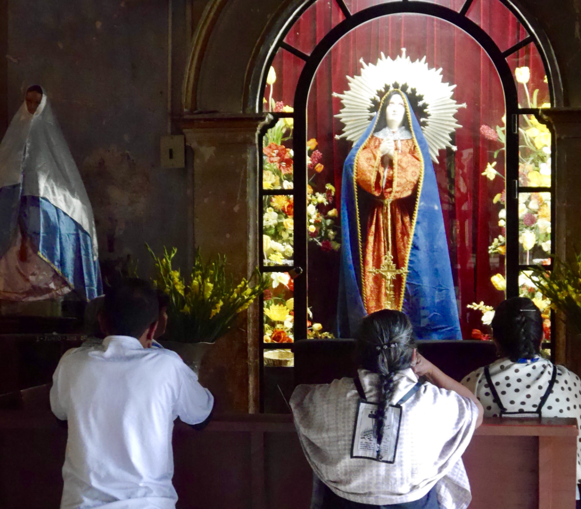 People Praying in front of Marian Altar - Catholic Stock Photo