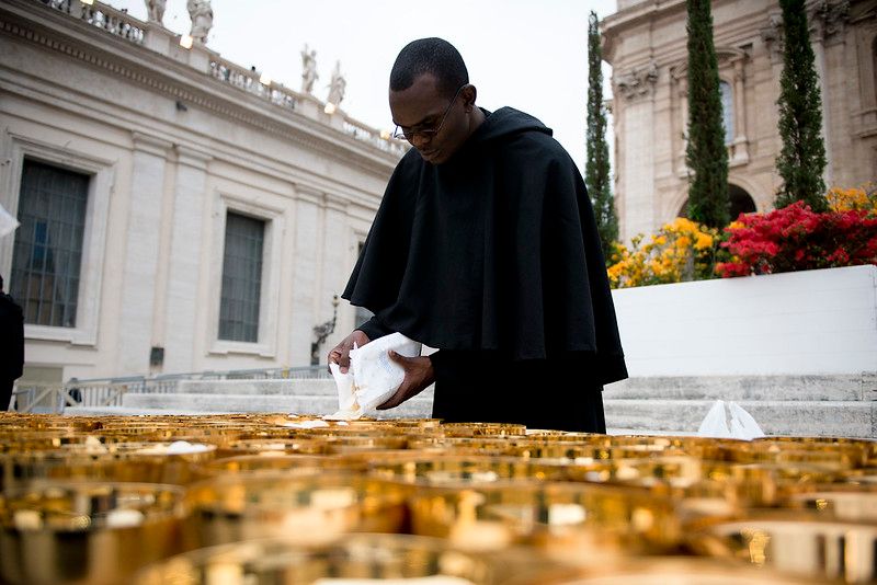 Monk Preparing Communion at Canonization of Saint John Paul II (2014) - Catholic Stock Photo