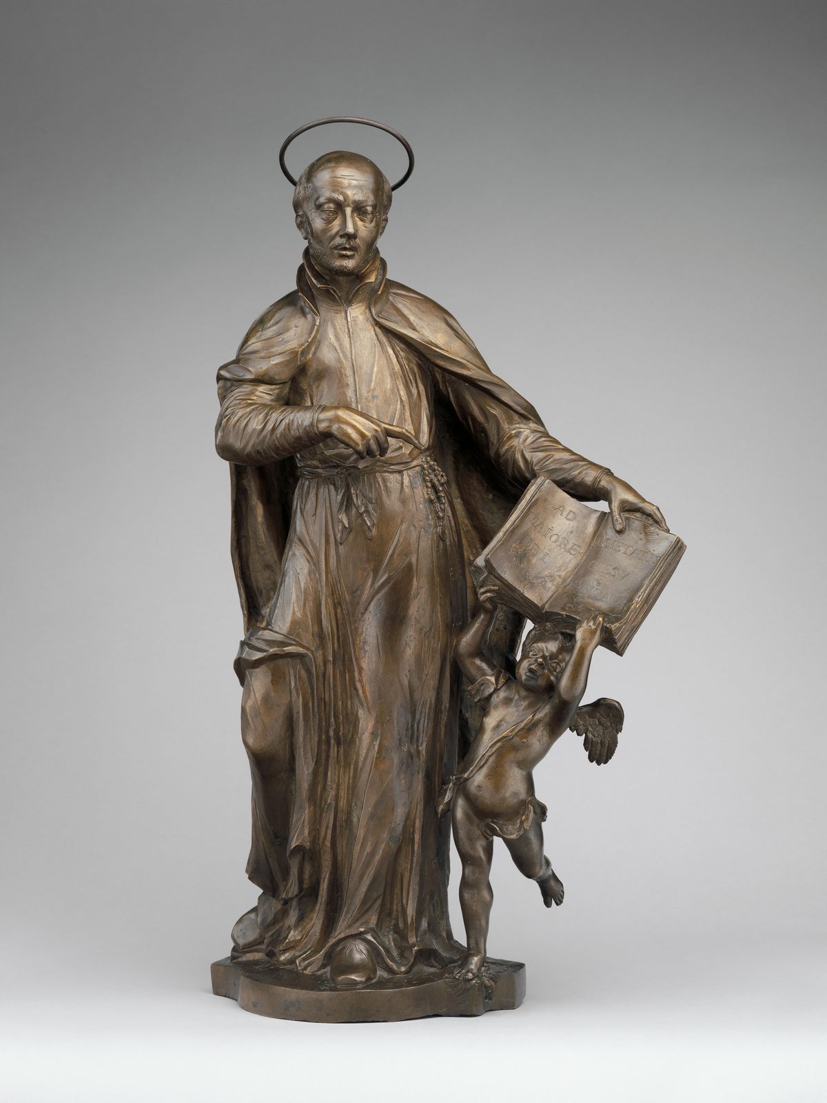 Saint Ignatius Loyola with an angel holding a book (1722) by Francesco Bertos - Catholic Stock Photo