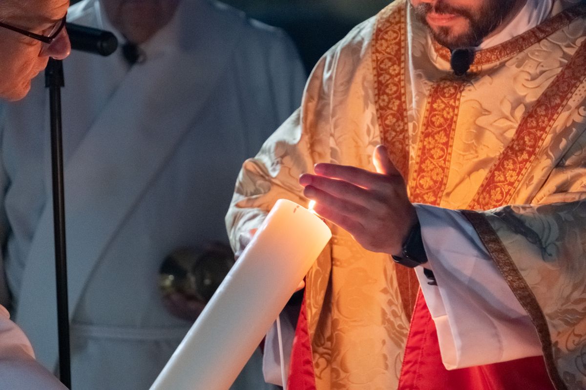 Priest Lighting the Pascal Candle at the Easter Vigil (2023, Holy Spirit Catholic Church, Virginia Beach, Virginia, United States) - Catholic Stock Photo